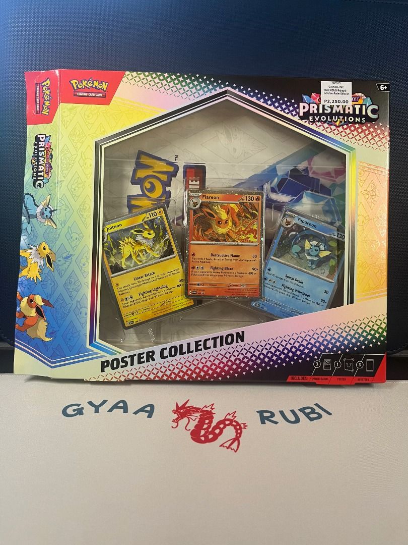 Pokémon Prismatic Evolutions – Poster Collection (WITHOUT BOOSTER PACKS) (Category: Raw Singles) located in Makati City. Submitted by chapangya (Listing ID 1406444048, Image 1). Description: Condition: Opened – booster packs already ripped, but ALL non-pack contents are complete and untouched. Includes: ✔️ 3 Promo Cards (Jolteon, Vaporeon, Flareon) – NM ✔️ Poster (folded as originally included) ✔️ Code Card ✔️ Original box (opened, minor handling