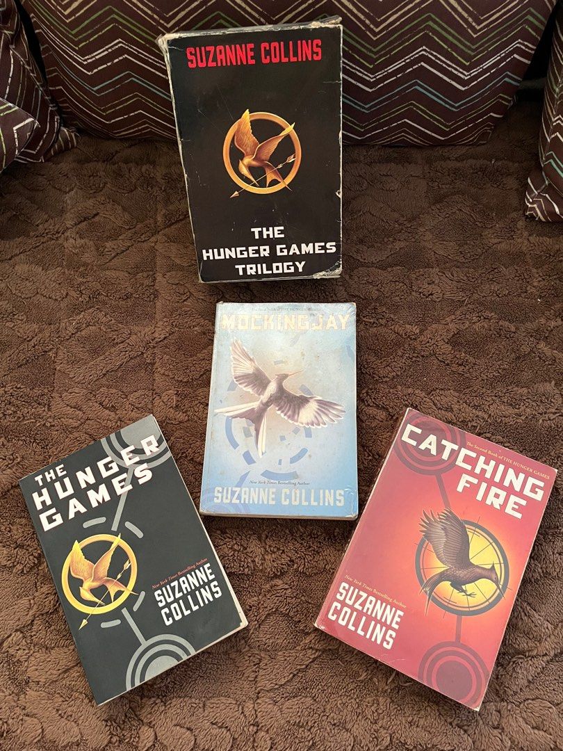 The Hunger Games Trilogy by Suzanne Collins (Category: Storybooks) located in Manila. Submitted by zenwhale-c20d (Listing ID 1406304952, Image 1). Description: - Complete Hunger Games trilogy - Includes "The Hunger Games", "Catching Fire", and "Mockingjay" - All books in English - Ideal for dystopian YA fans - Great for reading or collecting.
