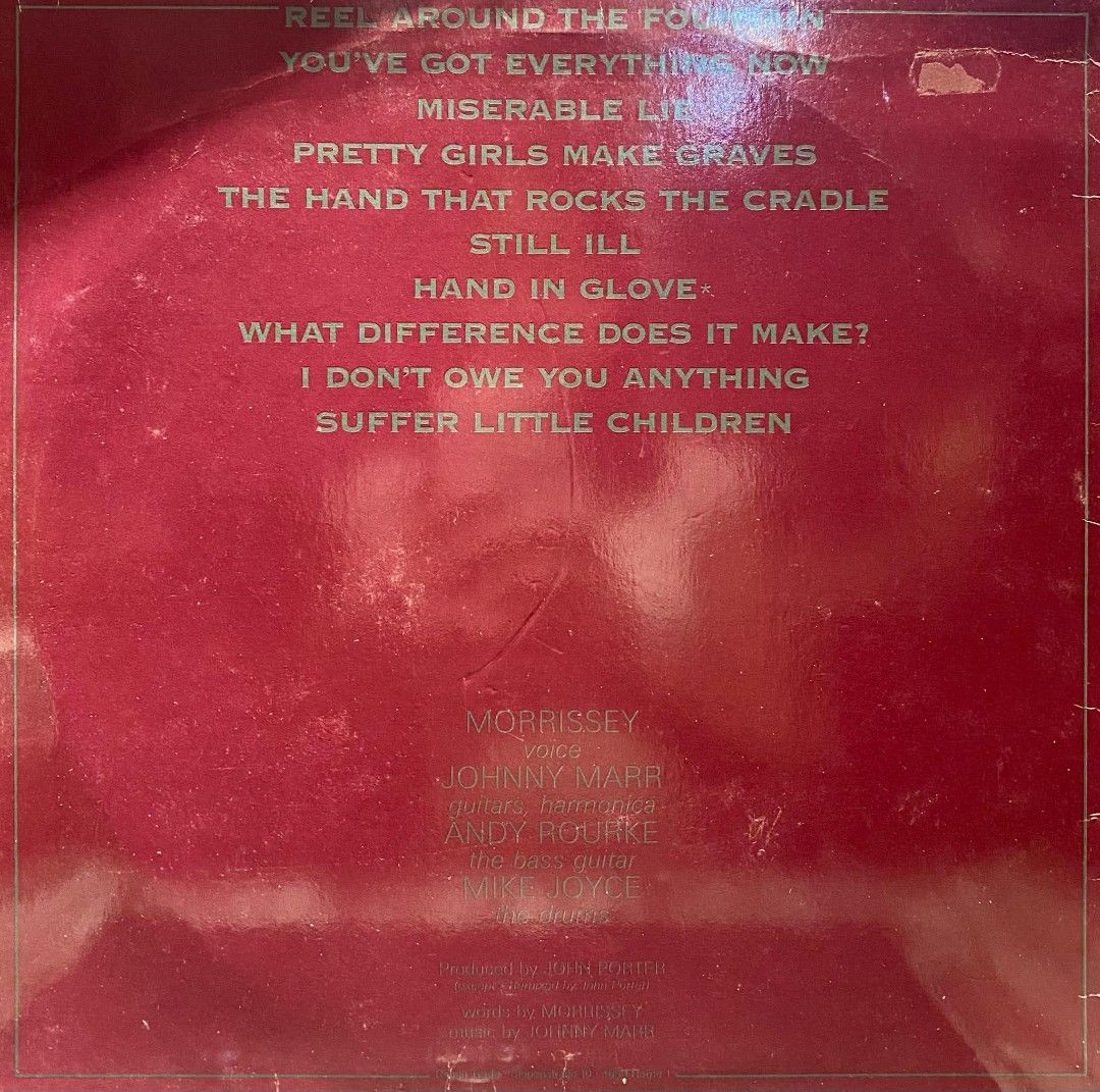 The Smiths - The Smiths Vinyl Record (Category: Vinyls) located in Quezon City. Submitted by pooh_laa (Listing ID 1406285876, Image 2). Description: Smiths self-titled debut album on vinyl. Features tracks like "Reel Around the Fountain", "You've Got Everything Now", and "Miserable Lie". The back cover lists the tracklist and credits Morrissey, Johnny Marr, Andy Rourke, and Mike Joyce. Produced by Rough Trade. VG++ Condition .