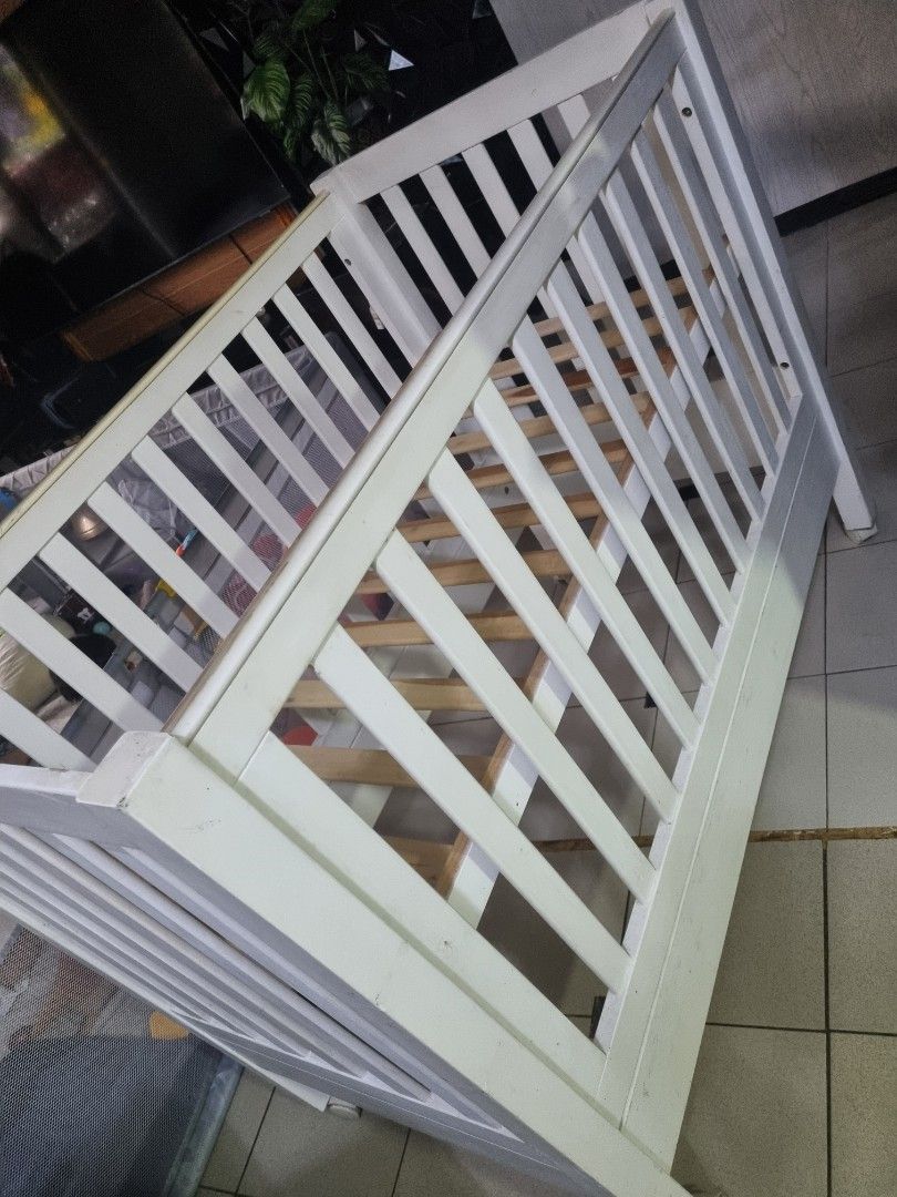 White Wooden Baby Crib (Category: Cots & Cribs) located in Imus. Submitted by naomi_29 (Listing ID 1406365866, Image 3). Description: - White wooden baby crib - Well-constructed - Ideal for baby's sleeping area - with foam .