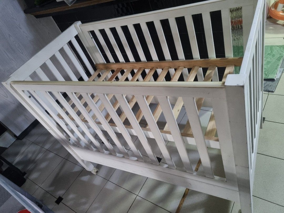White Wooden Baby Crib (Category: Cots & Cribs) located in Imus. Submitted by naomi_29 (Listing ID 1406365866, Image 1). Description: - White wooden baby crib - Well-constructed - Ideal for baby's sleeping area - with foam .