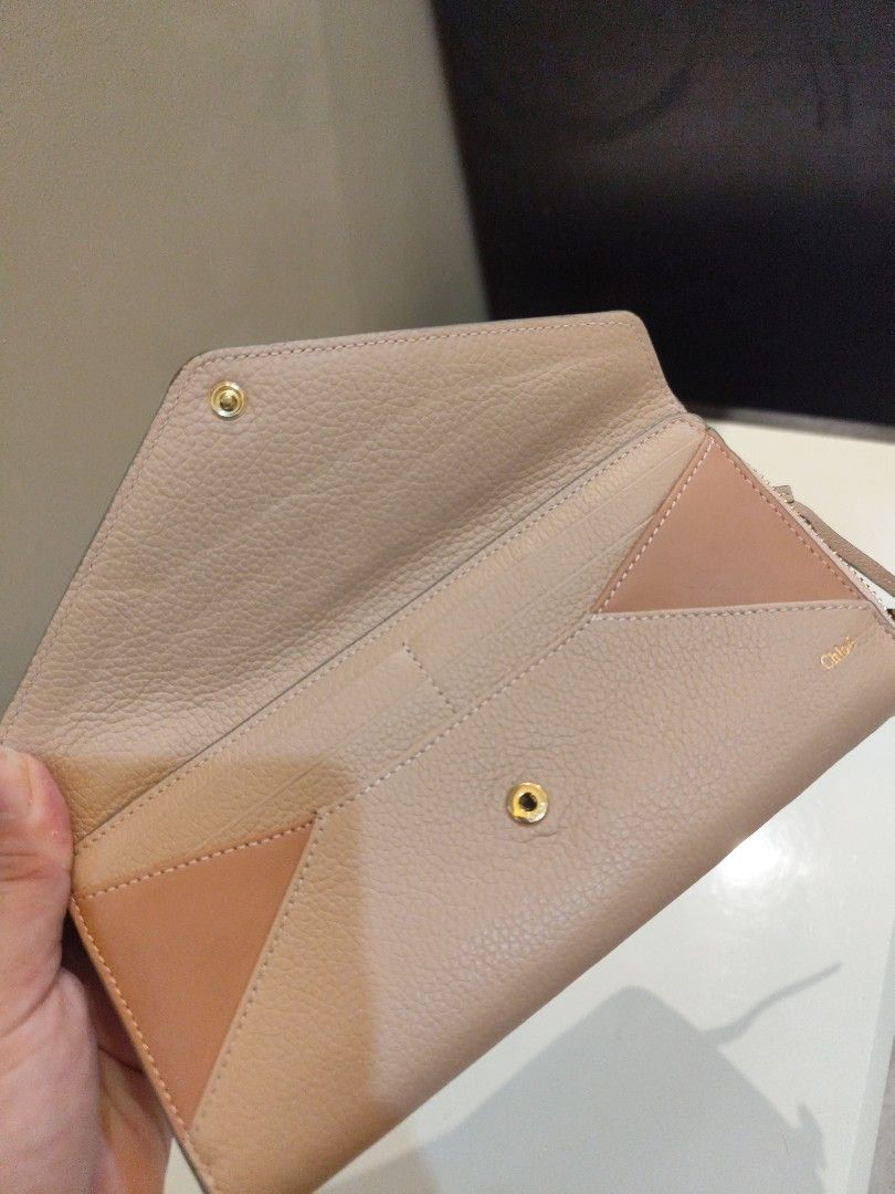 Authentic Chloe Leather Zip Around Wallet (Category: Luxury Bags & Wallets) located in Manila. Submitted by nnnlim (Listing ID 1406509240, Image 2). Description: - Authentic Chloe wallet - Zip-around closure - Bi-color design: Light pink and beige - Multiple card slots - Coin compartment - Includes wrist strap - Made of leather - Chloe logo detail.