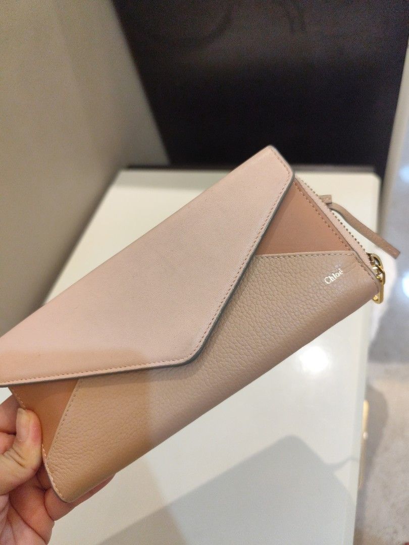 Authentic Chloe Leather Zip Around Wallet (Category: Luxury Bags & Wallets) located in Manila. Submitted by nnnlim (Listing ID 1406509240, Image 1). Description: - Authentic Chloe wallet - Zip-around closure - Bi-color design: Light pink and beige - Multiple card slots - Coin compartment - Includes wrist strap - Made of leather - Chloe logo detail.