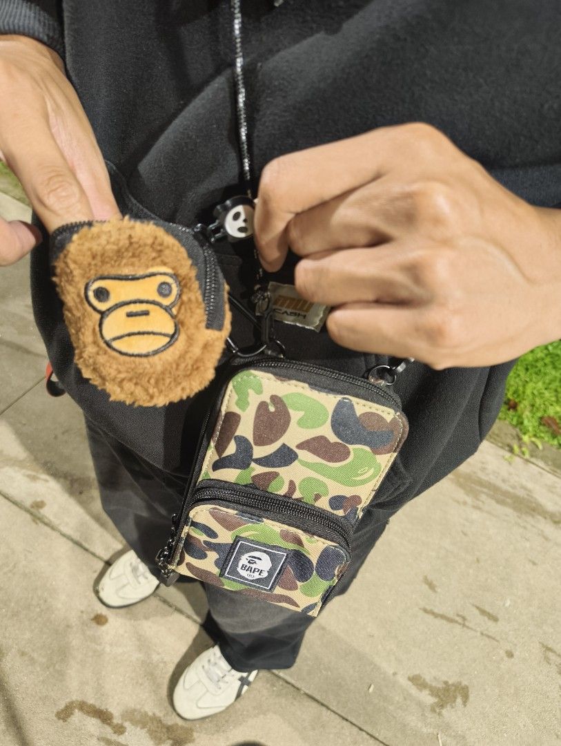 BAPE Camo Crossbody Bag with Wallet (Category: Luxury Bags & Wallets) located in Manila. Submitted by luh_markus (Listing ID 1406515363, Image 1). Description: 🎉Lowest in the market 🎉 - BAPE Crossbody Bag - Camo Pattern - Multiple card holder - Detachable Wallet Included - Small Backpack Design - BAPE Logo Patch - Includes Ape Head Coin Purse - Long Crossbody Strap - Multiple Compartments ‼️699 only plus sf‼️ Meet ups: Imus, Cavite only 💢 Cour