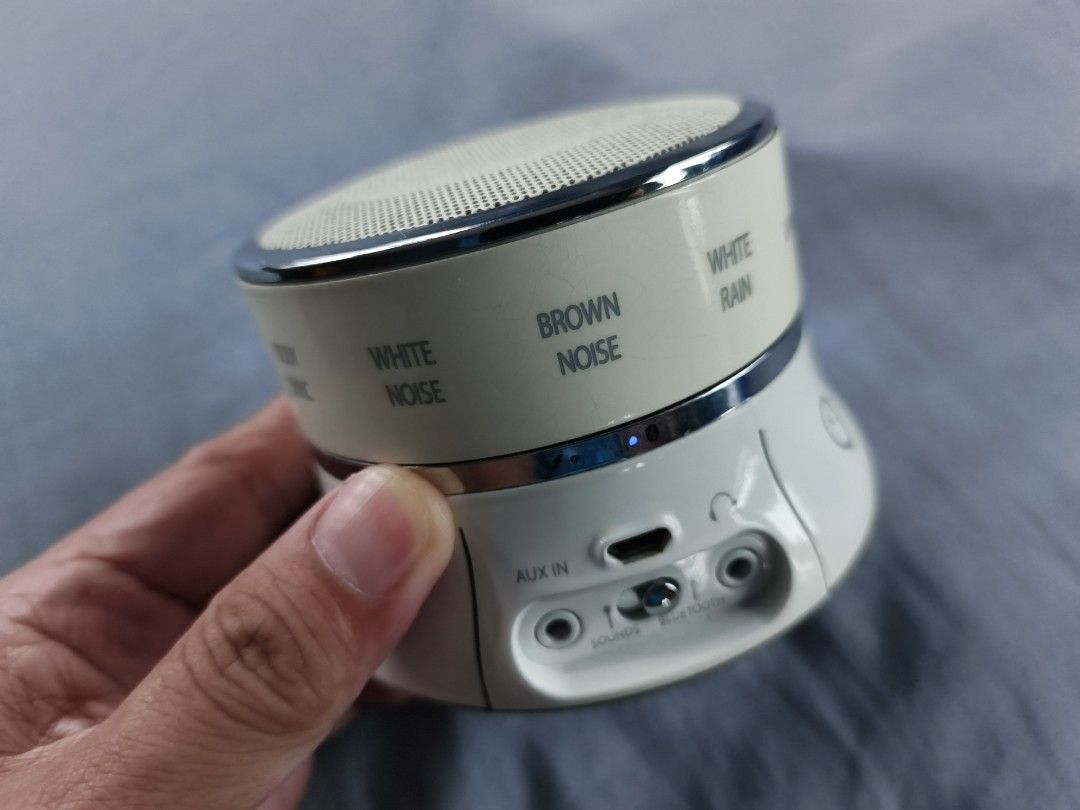 Brookstone Wireless Bluetooth Speaker (Category: Soundbars, Speakers & Amplifiers) located in Santa Ana. Submitted by lowerbasement (Listing ID 1406522146, Image 2). Description: - Brookstone Wireless Bluetooth Speaker - Sound Options: White noise, brown noise, rain, thunderstorm - Connectivity: Bluetooth and AUX input - Includes USB charging cable - Features power button and volume controls - Brookstone branding and model information on the bott