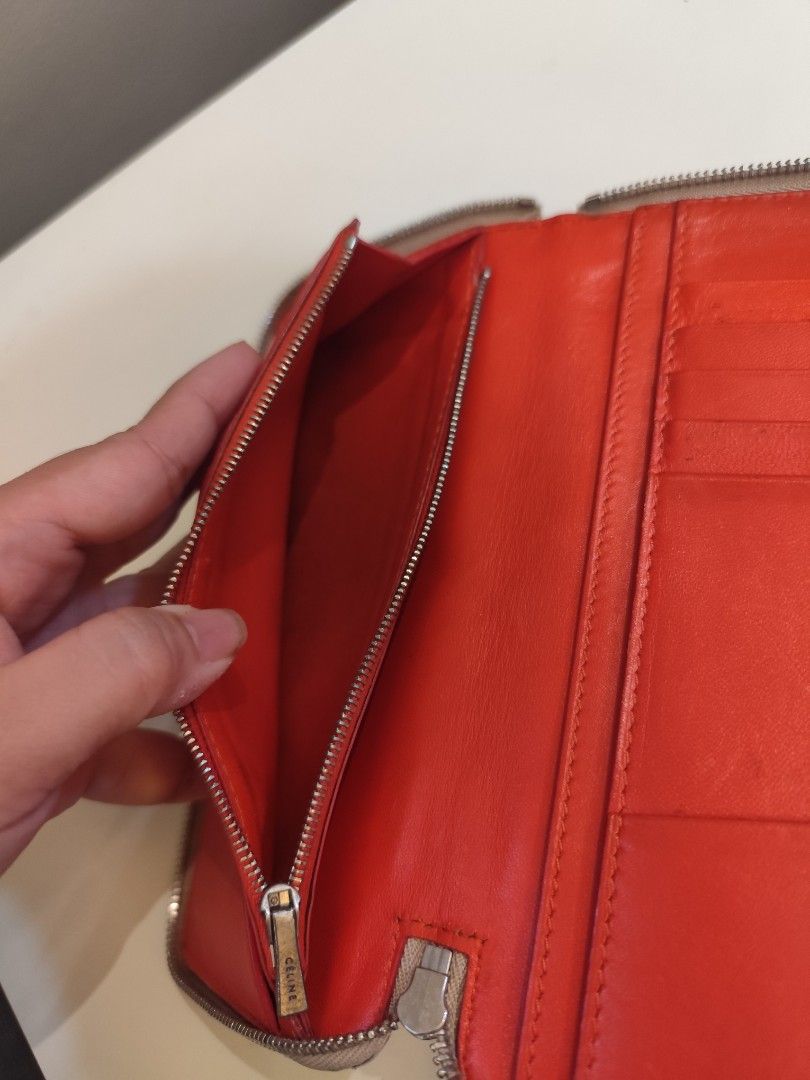 Authentic Celine Zip Around Wallet (Category: Luxury Bags & Wallets) located in Manila. Submitted by nnnlim (Listing ID 1406508245, Image 3). Description: - Celine zip around wallet - Neutral beige exterior - Red interior - Multiple card slots and compartments - Zip closure - Celine logo visible - Made in Italy.