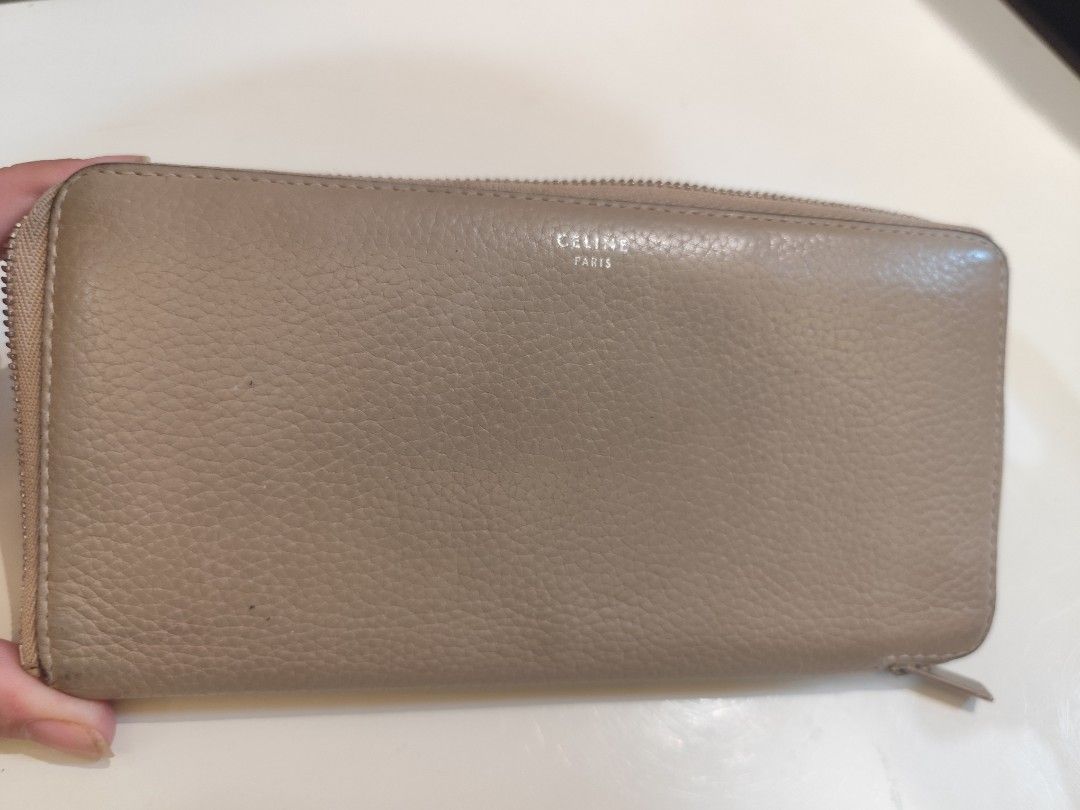 Authentic Celine Zip Around Wallet (Category: Luxury Bags & Wallets) located in Manila. Submitted by nnnlim (Listing ID 1406508245, Image 2). Description: - Celine zip around wallet - Neutral beige exterior - Red interior - Multiple card slots and compartments - Zip closure - Celine logo visible - Made in Italy.