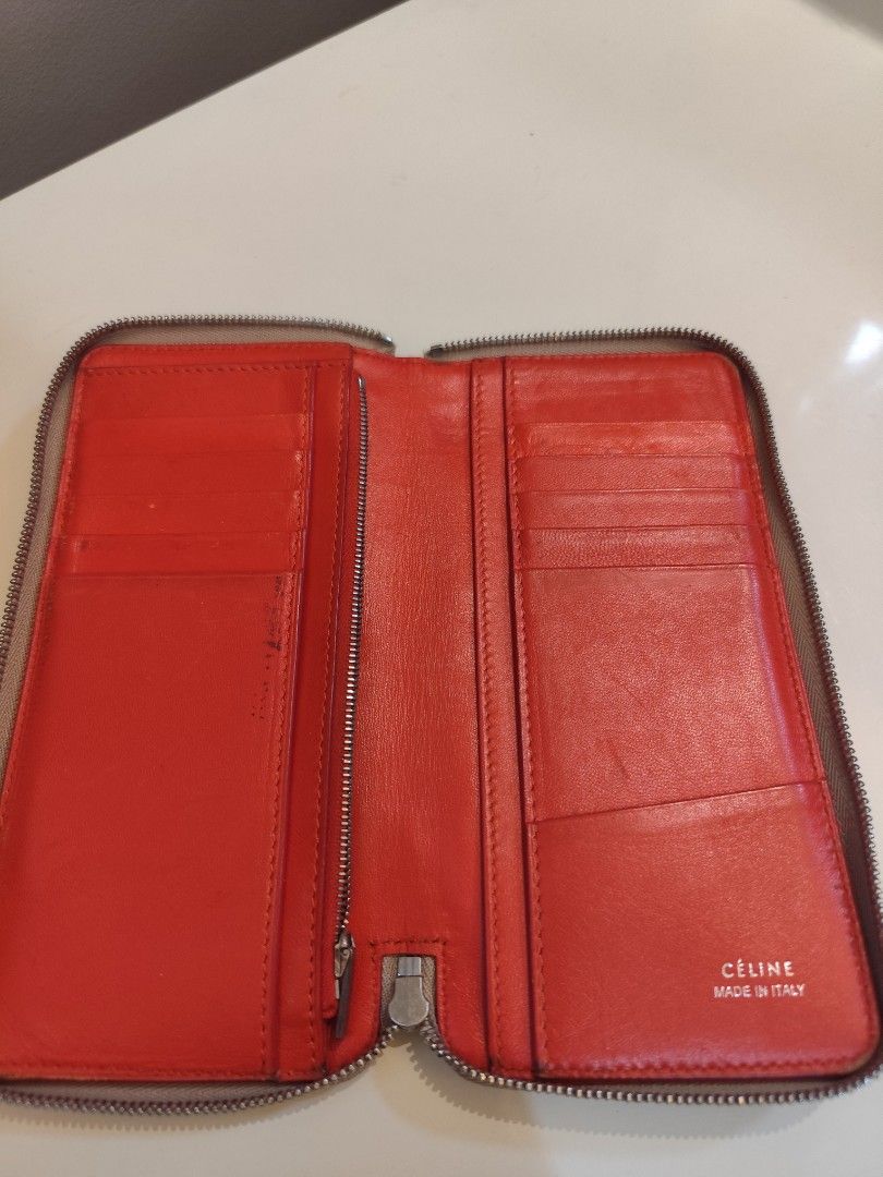 Authentic Celine Zip Around Wallet (Category: Luxury Bags & Wallets) located in Manila. Submitted by nnnlim (Listing ID 1406508245, Image 1). Description: - Celine zip around wallet - Neutral beige exterior - Red interior - Multiple card slots and compartments - Zip closure - Celine logo visible - Made in Italy.
