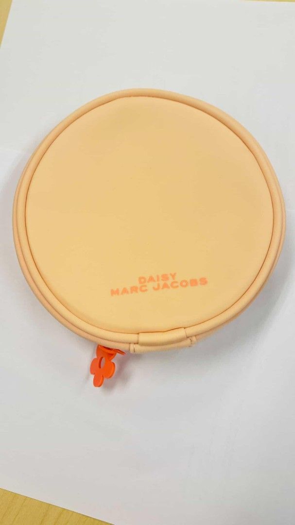 Daisy Marc Jacobs Cosmetic Pouch (Category: Luxury Bags & Wallets) located in Valenzuela. Submitted by aliehs.alo (Listing ID 1406477562, Image 1). Description: - Round cosmetic pouch - Daisy Marc Jacobs logo on front - Two zippered compartments -this was included when my friend bought a perfume.