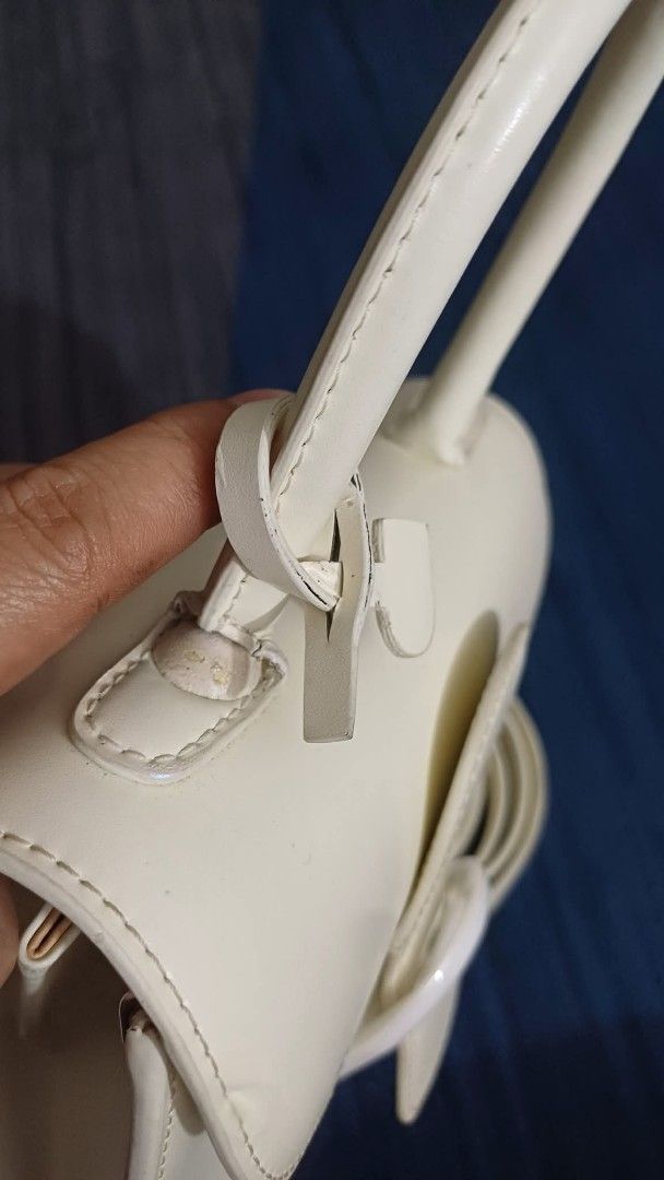 Delvaux White Handbag with Shoulder Strap (Category: Luxury Bags & Wallets) located in Batangas. Submitted by venus232nd (Listing ID 1406587517, Image 3). Description: - Delvaux white handbag - Top handle and detachable shoulder strap - Flap closure with buckle - Interior pocket - Metal feet - Made in France - Shoulder strap with signs of wear.