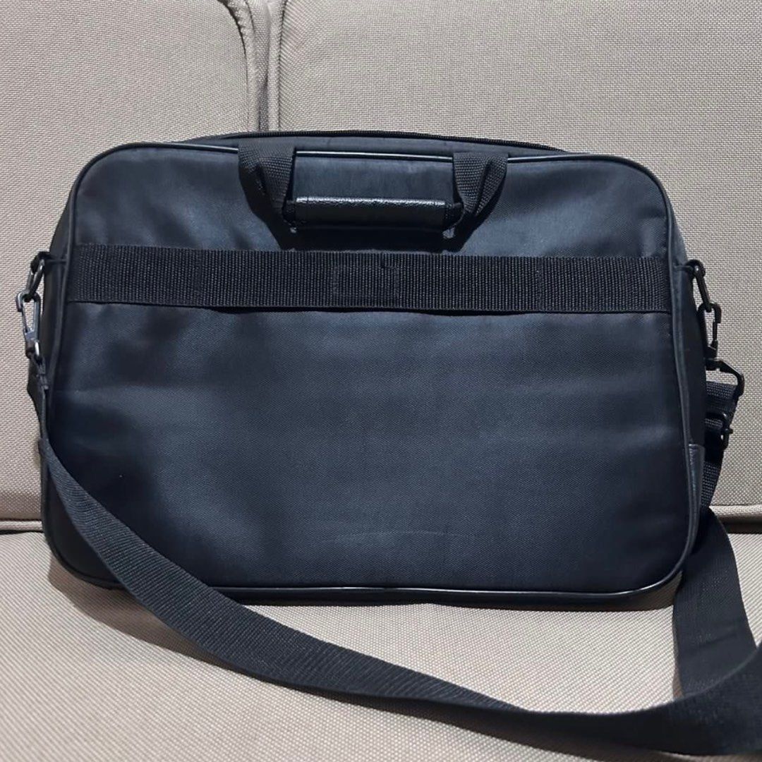 Dicota Laptop Bag (Category: Laptop Bags & Sleeves) located in Mandaluyong City. Submitted by ysxbelx (Listing ID 1406559050, Image 2). Description: - Dicota Black laptop bag - Includes a shoulder strap and handle, Front pocket with red zipper pull - Leather-like panel at the bottom Location: Mandaluyong MOP: Gcash, Maya, BPI MOD: Delivery to be booked by Buyer, J&T for Provincial .