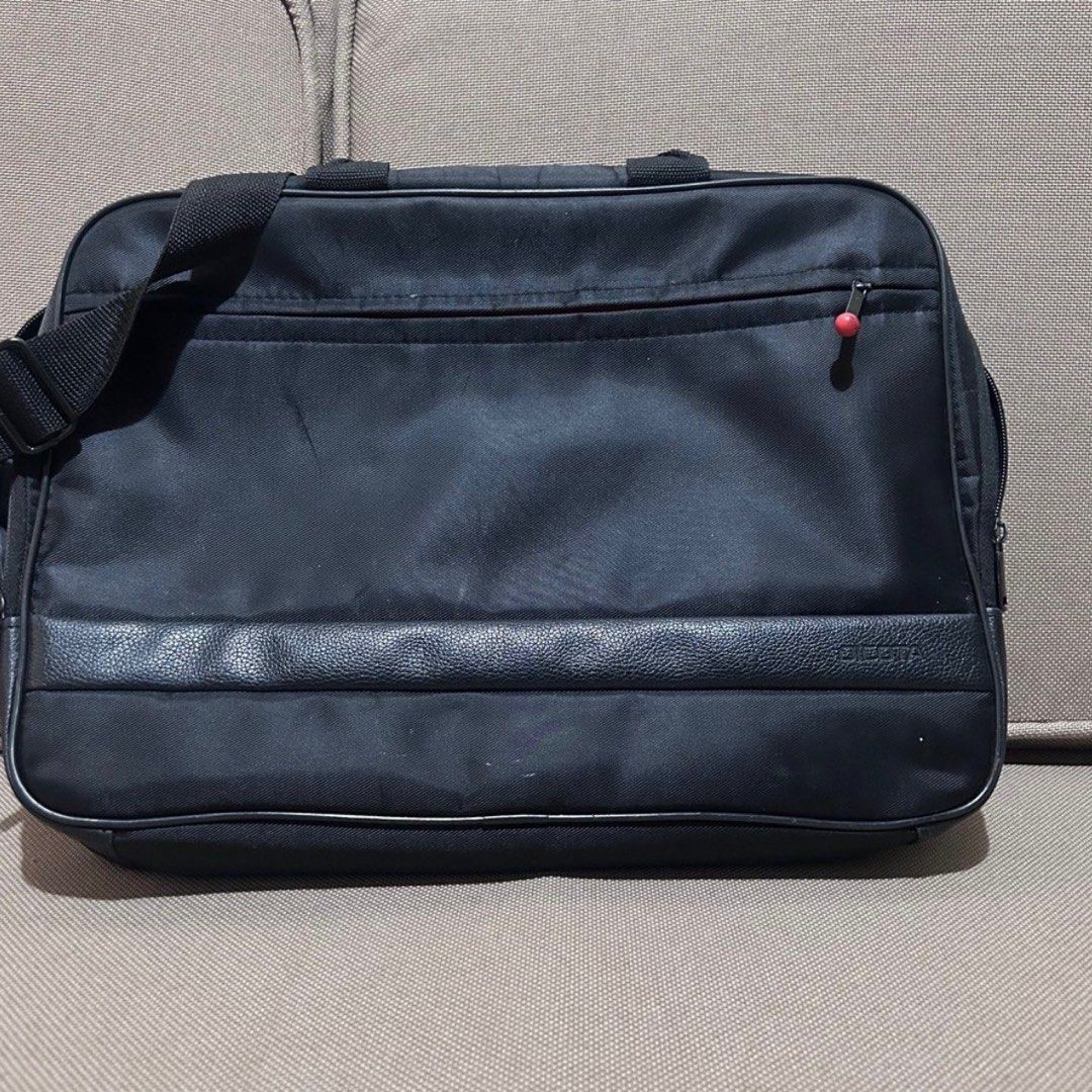 Dicota Laptop Bag (Category: Laptop Bags & Sleeves) located in Mandaluyong City. Submitted by ysxbelx (Listing ID 1406559050, Image 1). Description: - Dicota Black laptop bag - Includes a shoulder strap and handle, Front pocket with red zipper pull - Leather-like panel at the bottom Location: Mandaluyong MOP: Gcash, Maya, BPI MOD: Delivery to be booked by Buyer, J&T for Provincial .