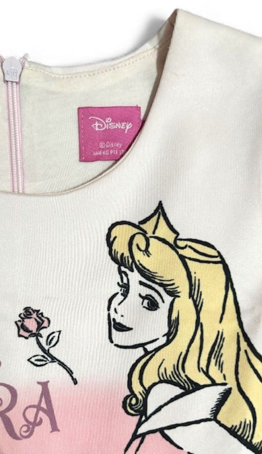 Disney Princess Aurora Dress (Category: Babies & Kids Fashion) located in Subic. Submitted by kylys.corner (Listing ID 1406544032, Image 3). Description: - Princess Aurora-themed dress - Features a round neckline and short sleeves - Fitted bodice with a flared skirt - Pink gradient front design - Aurora's name and quote on the front - Plain back - Back zipper closure - size 6 - Like new (Used just 2–3 times, in great condition).