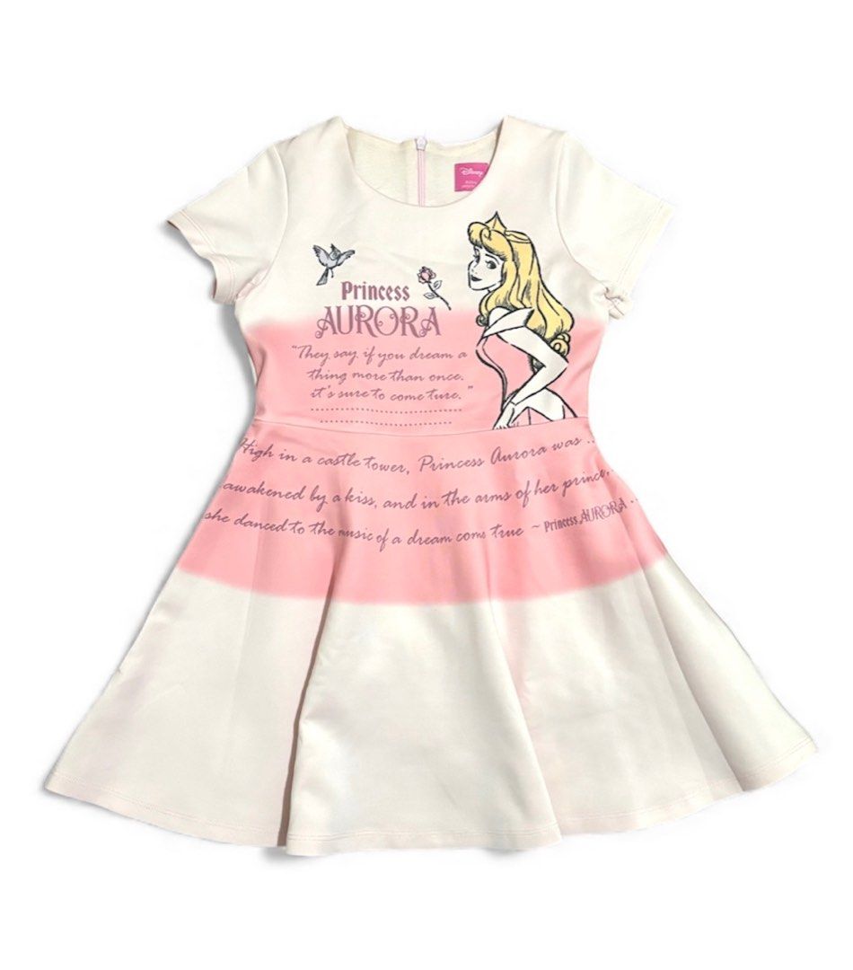 Disney Princess Aurora Dress (Category: Babies & Kids Fashion) located in Subic. Submitted by kylys.corner (Listing ID 1406544032, Image 1). Description: - Princess Aurora-themed dress - Features a round neckline and short sleeves - Fitted bodice with a flared skirt - Pink gradient front design - Aurora's name and quote on the front - Plain back - Back zipper closure - size 6 - Like new (Used just 2–3 times, in great condition).