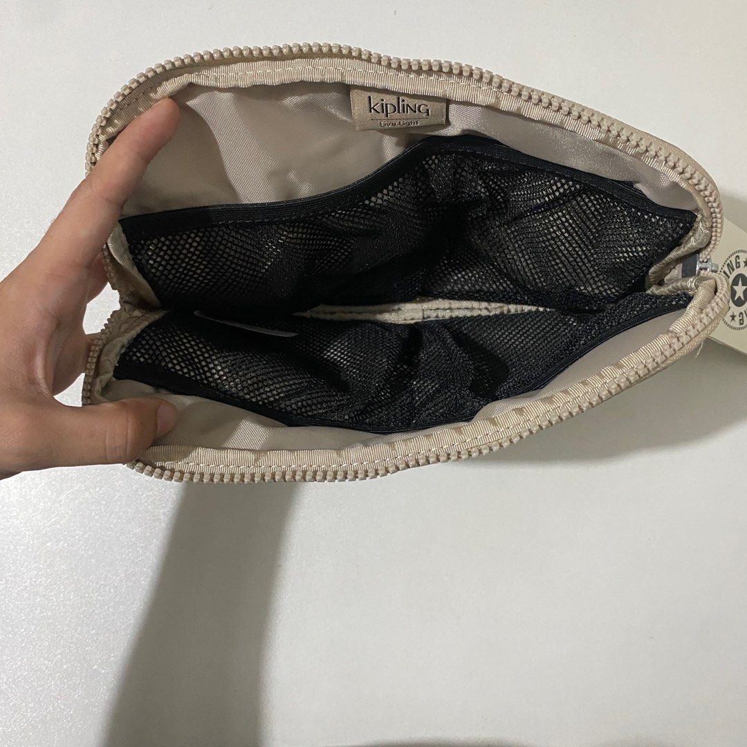 Kipling Lex Pouch Gleaming Gold Metallic (Category: Purses & Pouches) located in Quezon City. Submitted by saayymm (Listing ID 1406585784, Image 3). Description: - Color: Gleaming Gold Metallic - Material: Made from Kipling's signature water-resistant nylon material. - Dimensions: 9.5 inches (L) x 6.5 inches (H) - Closure: Zipper closure. - Interior: Features organizational pockets, including a slip pocket. - Exterior: The design is simple and co