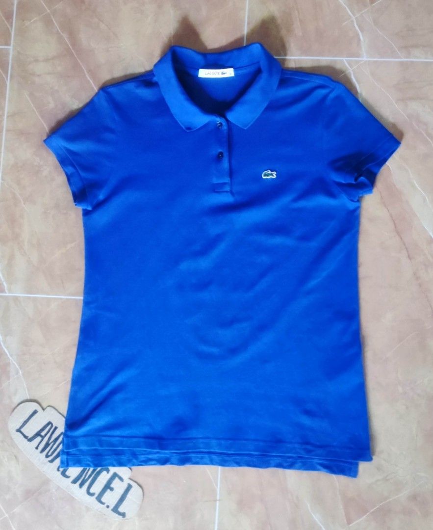 Lacoste Blue Polo Shirt (Category: Tshirts & Polo Shirts ) located in Taguig. Submitted by lawrence_stuff (Listing ID 1406526356, Image 1). Description: - Authentic Lacoste polo shirt - Vibrant blue color -Dimension 18/24 - Features the iconic Lacoste crocodile logo - Made in China - Size: 40 - Material: Cotton and elastane blend - Classic polo collar and short sleeves - Perfect for a casual look.