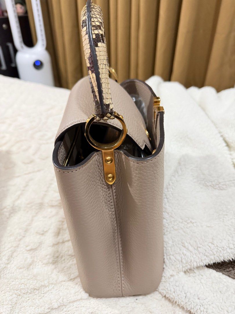 Louis Vuitton Capucines Mini Handbag (Category: Luxury Bags & Wallets) located in Manila. Submitted by luxurychicc (Listing ID 1406313708, Image 3). Description: - Authentic Louis Vuitton Capucines Mini - Neutral color - Textured leather body - Snakeskin design handle - Iconic LV logo - Perfect for any occasion Complete inclusuon with certificate from DENR.