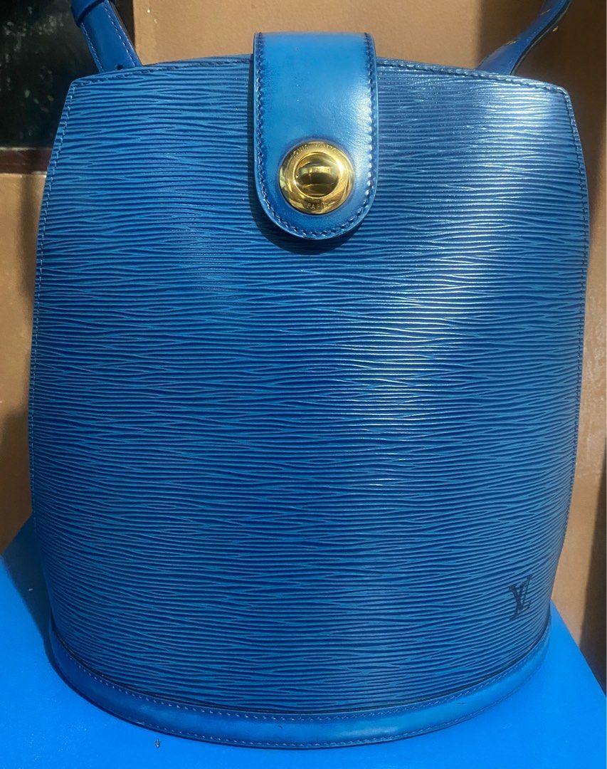 Louis Vuitton Epi Leather Bag Blue (Category: Luxury Bags & Wallets) located in Quezon City. Submitted by maismaria (Listing ID 1406624000, Image 2). Description: - Authentic Louis Vuitton Epi Cluny Bag - Color: Toledo Blue - Design: Bucket shape - Features: Top handle and shoulder strap - Closure: Flap with gold-tone clasp - Interior: Matching blue lining - Shape: Oval bottom - Details: Louis Vuitton logo on front The leather on the opening stra