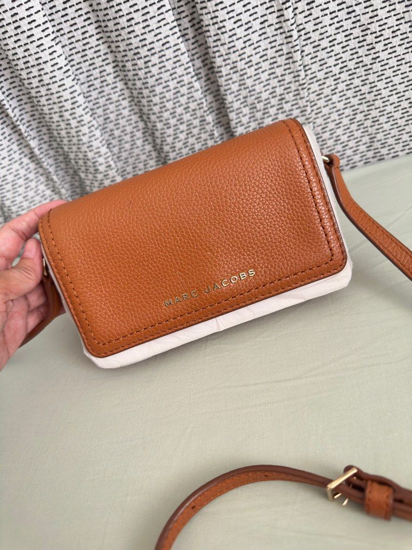 Marc Jacobs Groove Leather Mini Crossbody Bag (Category: Luxury Bags & Wallets) located in Cavite. Submitted by sayo_nato (Listing ID 1406540424, Image 1). Description: - Marc Jacobs Groove Mini Crossbody Bag - Brown leather exterior - White trim - Flap closure - Adjustable shoulder strap - Fabric-lined interior - Brand label inside - Perfect for everyday use.