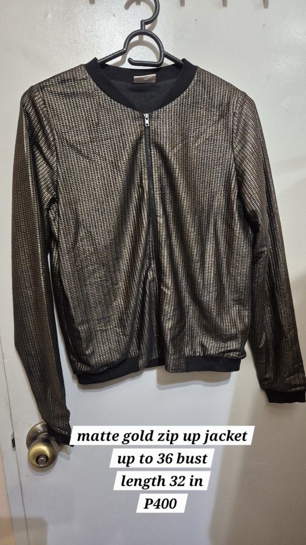 Matte Gold/Bronze and Black Bomber Zip Up Jacket (Category: Coats, Jackets and Outerwear) located in Manila. Submitted by gcuraming (Listing ID 1406495935, Image 1). Description: - Matte gold finish - Zip-up closure - Fits up to 36" bust - Stylish and elegant shipping from sampaloc manila or makati.