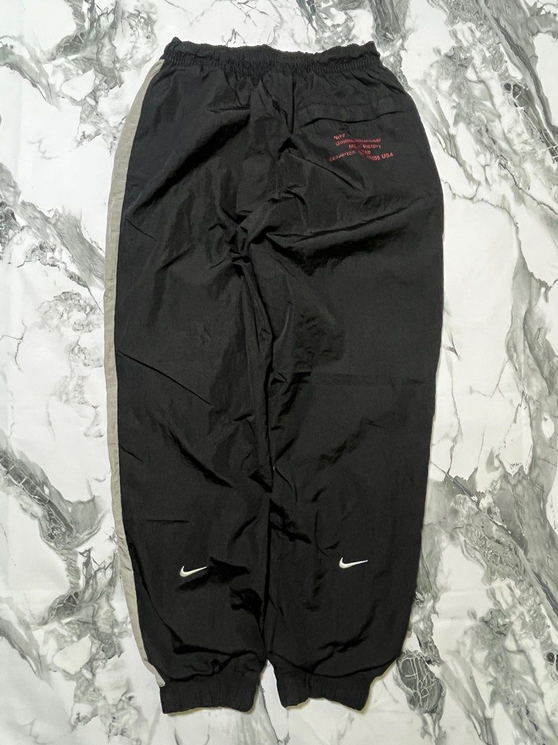 Nike Double Swoosh Track Pants - Black (Category: Joggers) located in Caloocan City. Submitted by yungbluhh (Listing ID 1406528742, Image 2). Description: - Black Nike track pants with grey side panels - Features Nike double swoosh logo on front - Smaller Nike logo on back - Elastic waistband and cuffs - Size: Small.