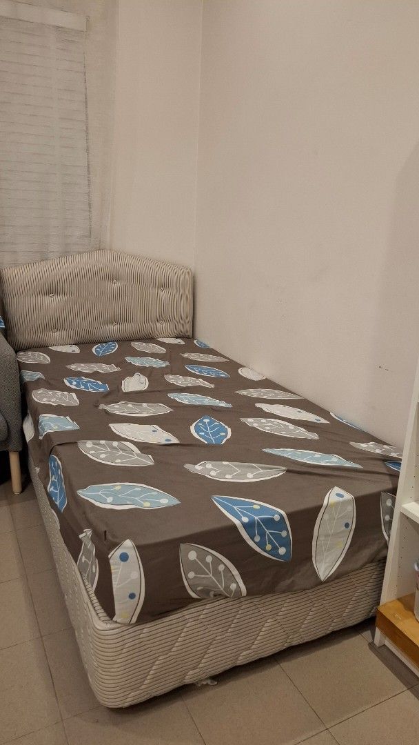 Single Bed with Leaf Pattern (Category: Bed Frames & Mattresses) located in Puchong. Submitted by 2ndchance2u (Listing ID 1406598550, Image 1). Description: Super Single (Hotel Quality) Retail @1k ++ Didn't Use before. Covered in bedsheet to avoid dust build-up. - Single bed frame - Upholstered headboard with striped fabric - Wooden bed frame - Includes bedsheet - Bedsheet features brown background with blue and white leaf patterns - Side of bed 