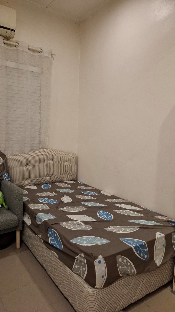 Single Bed with Leaf Pattern (Category: Bed Frames & Mattresses) located in Puchong. Submitted by 2ndchance2u (Listing ID 1406598550, Image 2). Description: Super Single (Hotel Quality) Retail @1k ++ Didn't Use before. Covered in bedsheet to avoid dust build-up. - Single bed frame - Upholstered headboard with striped fabric - Wooden bed frame - Includes bedsheet - Bedsheet features brown background with blue and white leaf patterns - Side of bed 