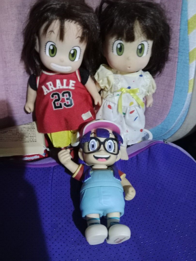Arale Norimaki Dolls (Category: Figurines & Statues) located in Muntinlupa City. Submitted by periwinklefairy23 (Listing ID 1406690736, Image 1). Description: - Arale Norimaki doll set - Includes three dolls: - Red basketball jersey - White dress - Overalls and glasses - Dolls have detailed facial features - Great for collectors and fans!.