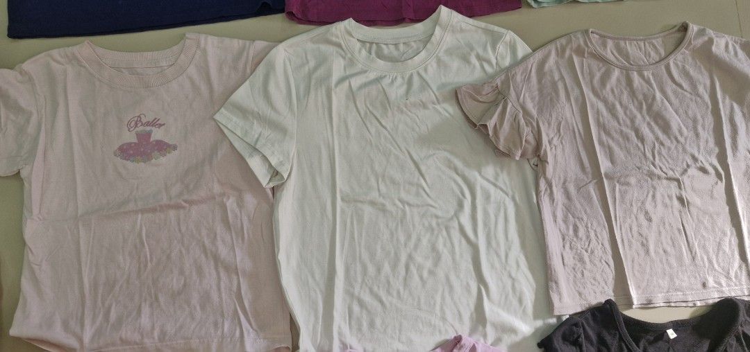 Assorted Graphic T-shirts (Category: Babies & Kids Fashion) located in Malolos. Submitted by prelovedclothes_stuff (Listing ID 1406750314, Image 3). Description: Collection of assorted graphic t-shirts in various colors and designs. Includes shirts with the phrases "Always Smile" and "ozork girl", as well as cat and ballet-themed graphics. Available in black, pink, white, purple, and blue. Sizes and specific brands are not specified..