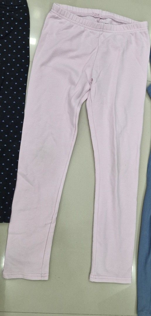 Assorted Leggings (Category: Babies & Kids Fashion) located in Malolos. Submitted by prelovedclothes_stuff (Listing ID 1406751962, Image 3). Description: Set of four leggings in various colors and styles. Includes a pair with a heart pattern, a pink pair, a blue pair with pockets, and a dark blue pair. The dark blue pair has a thin part. All leggings appear to be made of a comfortable, stretchy material. 5to7yo.