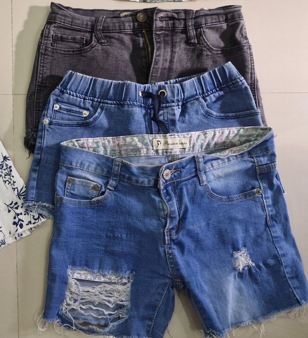 Assorted Tops and Shorts Bundle (Category: Babies & Kids Fashion) located in Malolos. Submitted by prelovedclothes_stuff (Listing ID 1406749176, Image 3). Description: - Bundle includes: - Navy blue top with star detail - Floral cold-shoulder top - White floral dress - Three pairs of denim shorts (various washes, including distressed) - Perfect for a casual, stylish look..