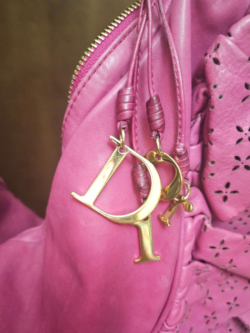 Authentic Dior Pink Leather Gypsy Ruffle Hobo (Category: Luxury Bags & Wallets) located in Antipolo. Submitted by frostymmer (Listing ID 1406802792, Image 3). Description: Authentic Dior Pink Leather Gypsy Ruffle Hobo With gold Dior letter charms Bag only - no inclusion Make space in your closet for this gorgeous Dior Gypsy hobo. The pretty pink bag is skilfully crafted from leather into a ruffled design that is truly feminine. It comes with the 