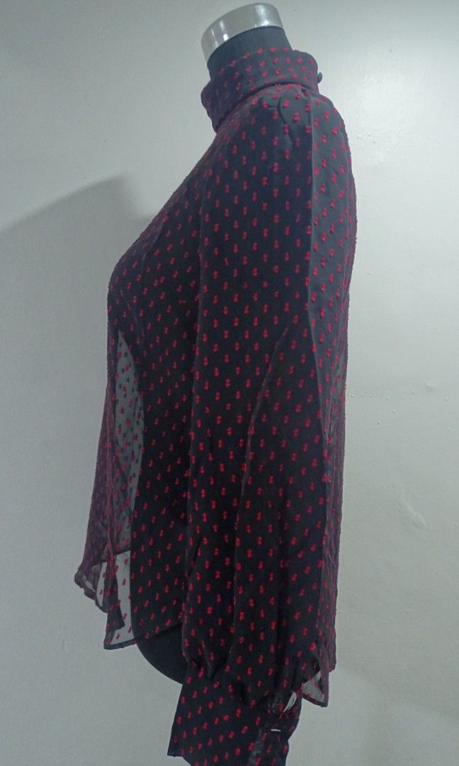 Black Sheer Long Sleeves (Category: Blouses) located in Bulacan. Submitted by aarchive (Listing ID 1406660886, Image 2). Description: - Black sheer long sleeves turtleneck blouse with red bow-like embroideries - Button-up detail on front and back - Perfect for a sophisticated look Fits Small to Medium MOP: Gcash/MAYA/BPI Shipping fee is shouldered by Buyer. Courier: J&T/Lalamove.