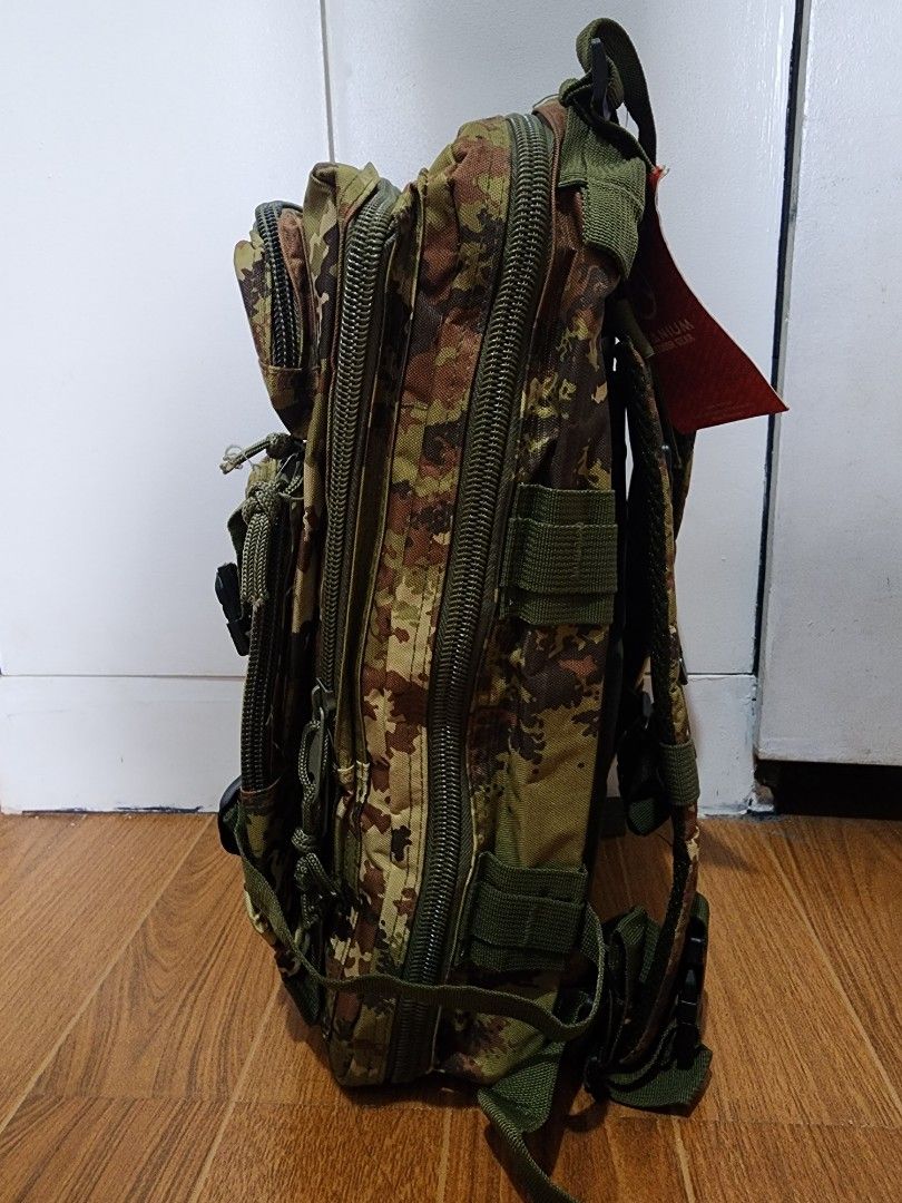 Camouflage Tactical Backpack (Category: Backpacks) located in Meycauayan. Submitted by MP_Shop (Listing ID 1406685921, Image 2). Description: - Camouflage pattern - Multiple compartments and zippered pockets - Adjustable straps and buckles - Top handle for carrying - Interior pockets (mesh and zippered) - Durable construction - Suitable for outdoor activities Size: 11W x 18L inches Excellent Condition Color rate: 10/10 850 + sf Loc: Meycauayan Bu
