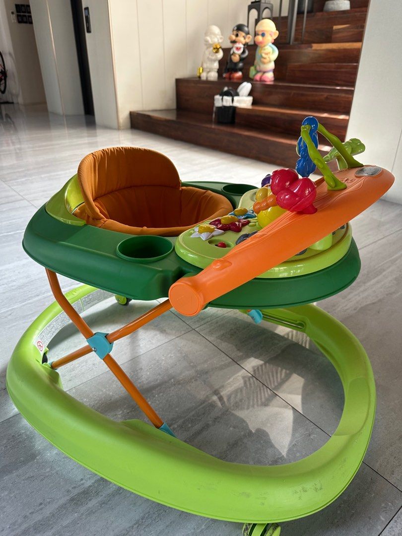 Chicco Baby Walker (Category: Infant Playtime) located in Angeles City. Submitted by shopmycloset_101 (Listing ID 1406648747, Image 1). Description: - Chicco baby walker - Bright green and orange design - Padded seat for comfort - Includes cup holders - Features an activity center with toys - Helps babies learn to walk.
