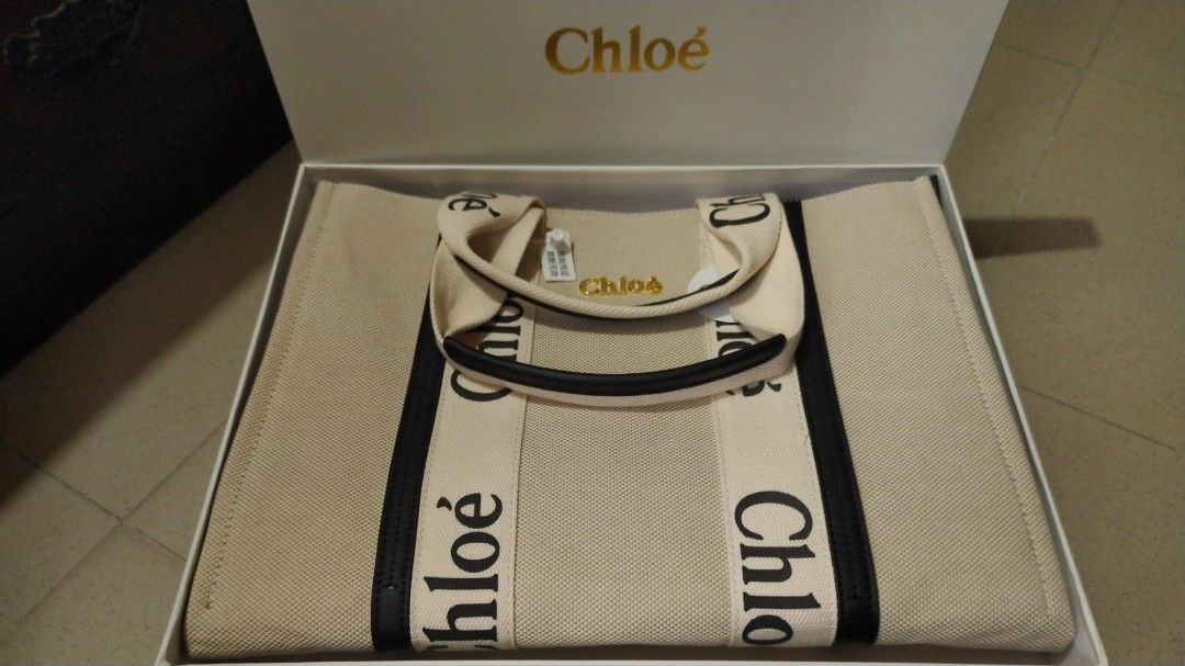 Chloe Woody Tote Bag (Category: Luxury Bags & Wallets) located in Bacoor. Submitted by anag729 (Listing ID 1406775269, Image 2). Description: - Chloe Woody tote bag - Beige canvas body - Black logo straps - Zip closure - Interior pocket - Gold-tone hardware - Includes box, tags - Spacious interior - Perfect for everyday use.