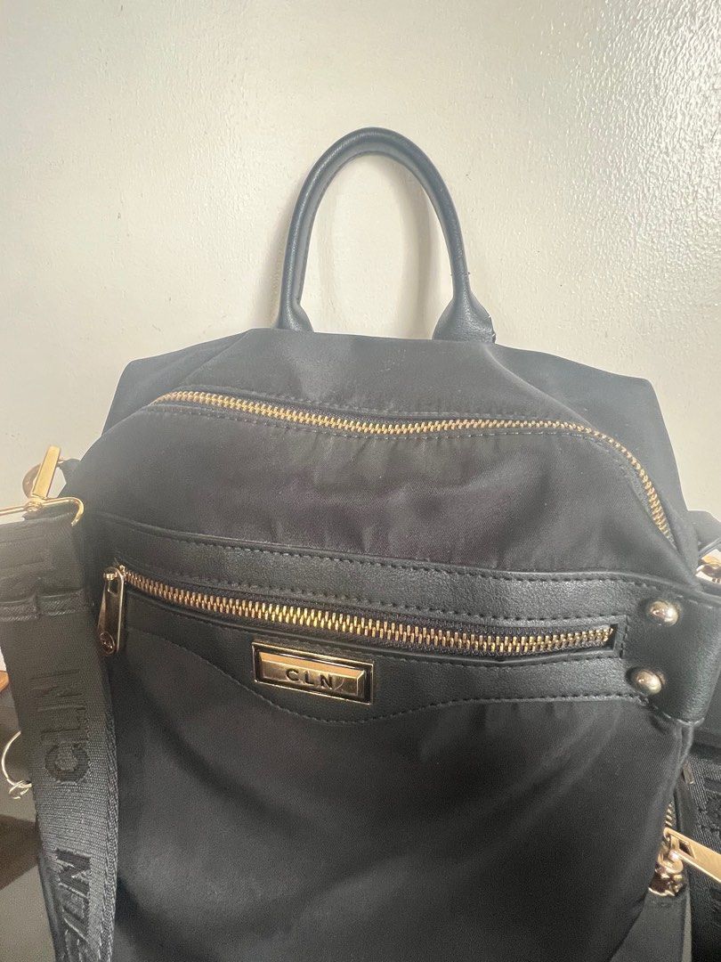 CLN Achazia Black Nylon Backpack (Category: Backpacks) located in Tuguegarao City. Submitted by aimurmere (Listing ID 1406689309, Image 3). Description: CLN Achazia backpack in black nylon with gold-tone hardware Orig Price: ₱2650 Two-way backpack with zip-around closure, padded laptop compartment fits up to 11.50” with velcro strap closure, 2 interior slip pockets, interior zipper pocket, 4 exterior zipper pockets, adjustable shoulder straps, Ny