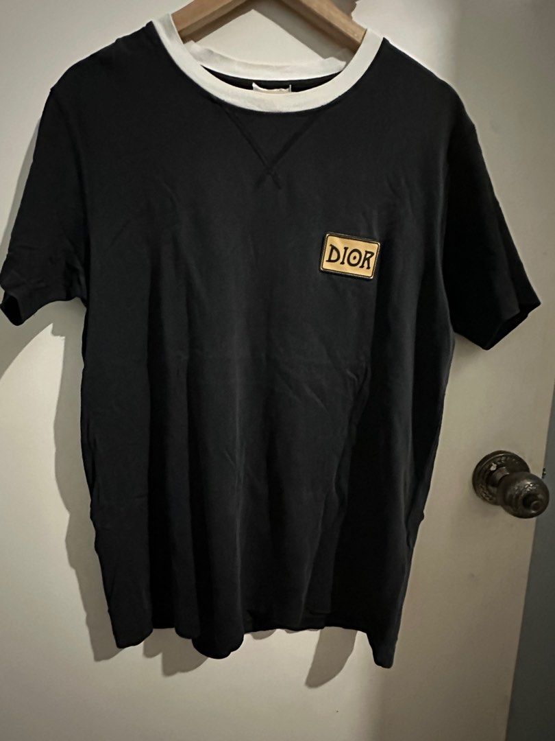 Dior Black T-shirt with White Collar (Category: Tshirts & Polo Shirts ) located in Cavite. Submitted by jessrms (Listing ID 1406657577, Image 1). Description: - Authentic Dior T-shirt - Color: Black with white collar - Features a Dior logo patch - Size: L - Material: 100% Cotton - Made in Italy.