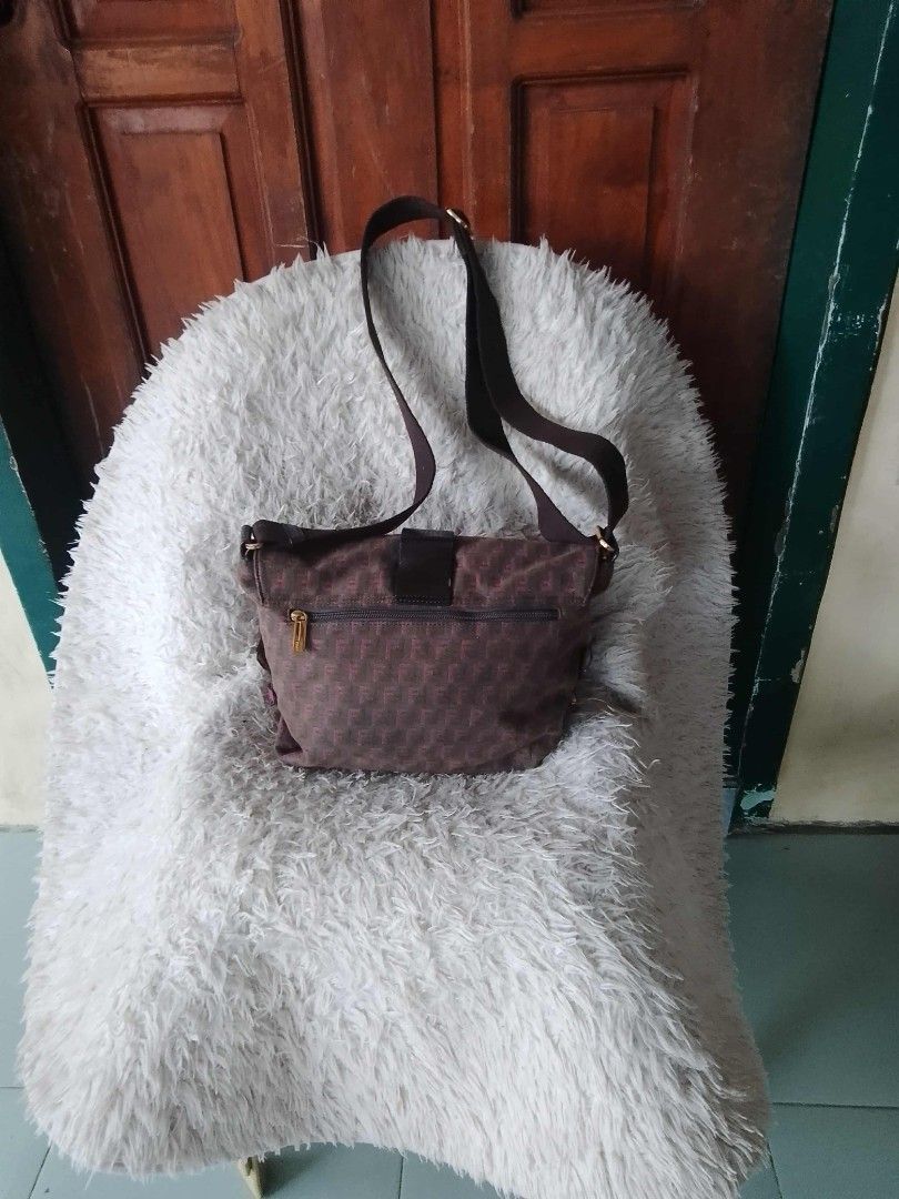 Fendi Shoulder Bag (Category: Luxury Bags & Wallets) located in Manila. Submitted by youngforest-2089 (Listing ID 1406768664, Image 2). Description: - Authentic Fendi shoulder bag - Brown with repeating pattern - Flap closure with gold-tone buckle - Long shoulder strap - Zipper closure - Interior pocket - Fendi logo visible - Made of textured material.