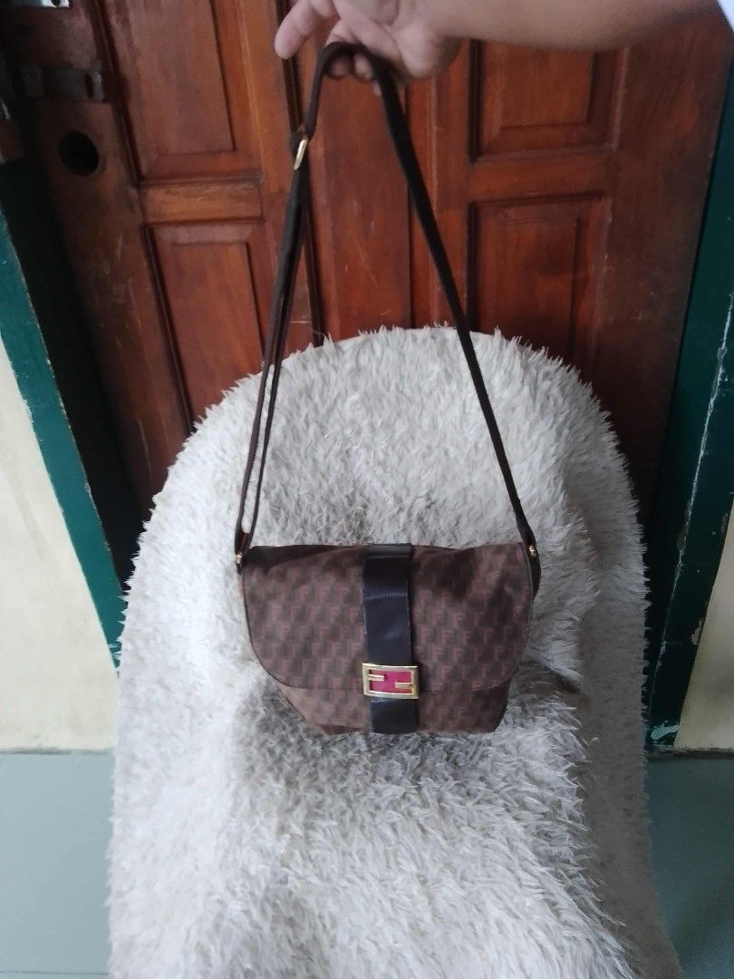 Fendi Shoulder Bag (Category: Luxury Bags & Wallets) located in Manila. Submitted by youngforest-2089 (Listing ID 1406768664, Image 3). Description: - Authentic Fendi shoulder bag - Brown with repeating pattern - Flap closure with gold-tone buckle - Long shoulder strap - Zipper closure - Interior pocket - Fendi logo visible - Made of textured material.