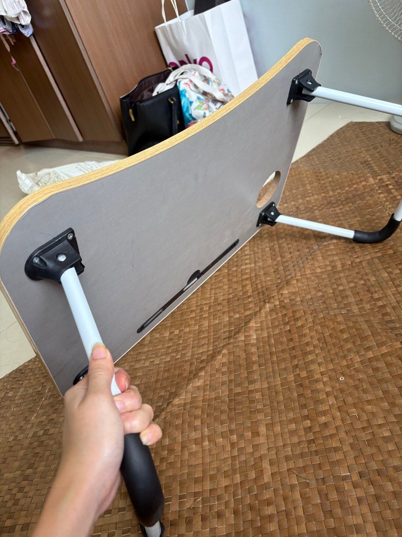 Foldable Laptop Table (Category: Tables & Sets) located in Manila. Submitted by pinpoints (Listing ID 1406684527, Image 2). Description: - Foldable laptop table - Wood-grain finish - Includes a slot for phone or tablet - White legs with black accents - Portable and easy to store .
