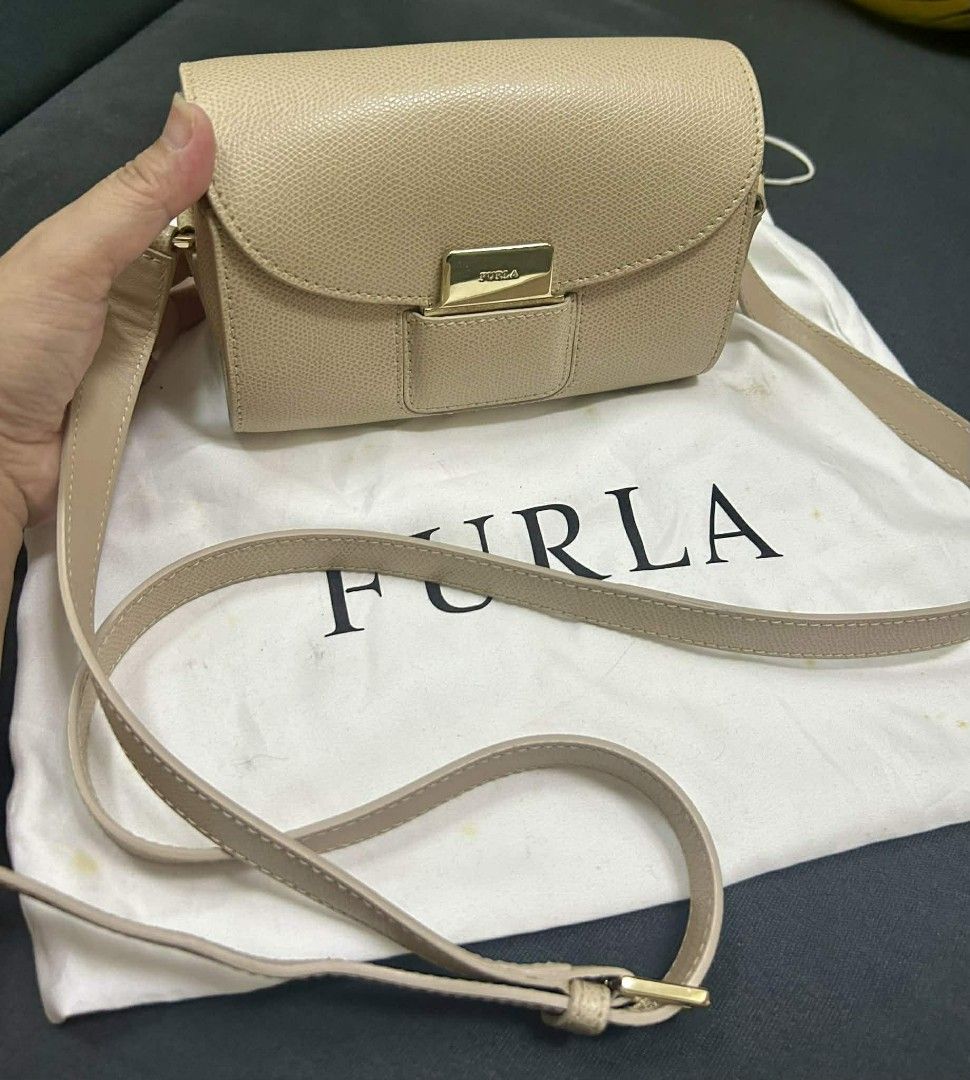 Authentic Furla Metropolis Crossbody Bag (Category: Luxury Bags & Wallets) located in Manila. Submitted by sterling_grace (Listing ID 1406764712, Image 1). Description: - Furla Metropolis crossbody bag - Neutral beige color - Flap closure with gold-tone clasp - Detachable shoulder strap - Interior pocket with Furla label - Includes Furla dust bag.