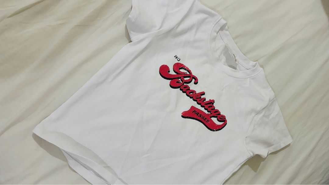 Graphic T-shirts - White, Gray, Brown (Category: Shirts) located in Las Pinas. Submitted by katb86 (Listing ID 1406728411, Image 3). Description: - Set of three graphic t-shirts. - Includes: - White tee with red "No Backstage Passes" design. - Gray tee with butterfly graphic. - Brown ribbed tank top with wing design (tag still attached)..