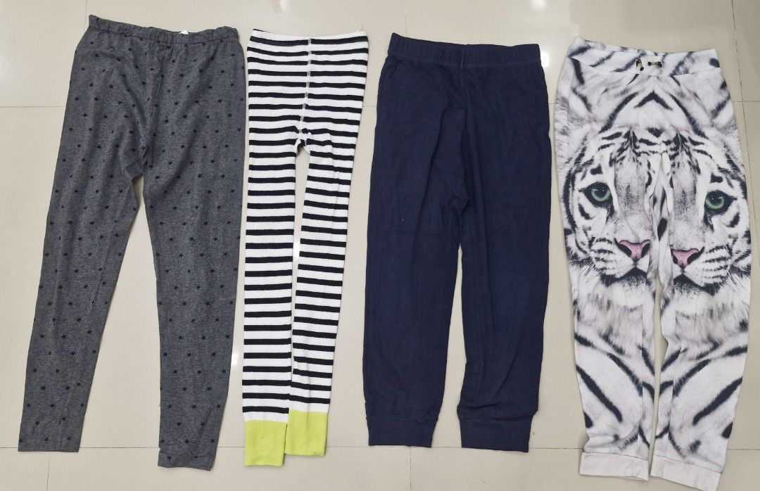 Kids' Assorted Pants (Category: Babies & Kids Fashion) located in Malolos. Submitted by prelovedclothes_stuff (Listing ID 1406751616, Image 1). Description: Set of kids' pants in various designs. Includes a pair of grey pants with black polka dots, striped leggings with yellow accents, navy blue pants, and a pair of white tiger print pants. All pants appear to be made of a soft, comfortable material. Perfect for everyday wear..