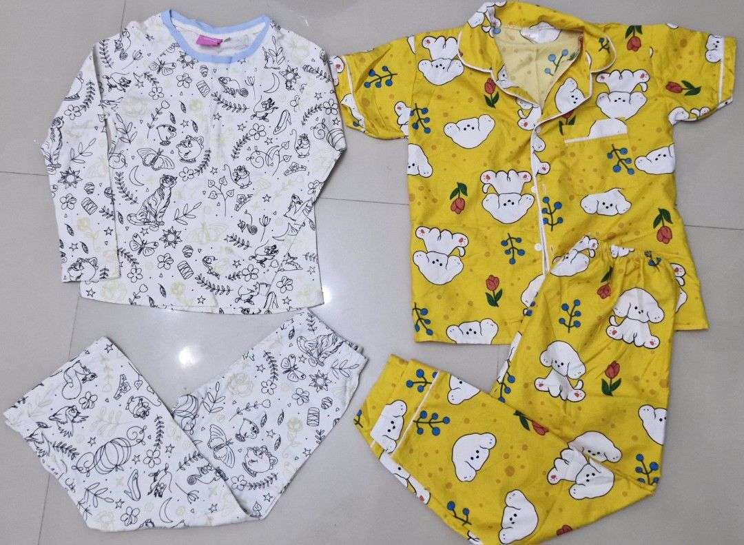 TAKE ALL Kids' Pajama Set - Cartoon Print (Category: Babies & Kids Fashion) located in Malolos. Submitted by prelovedclothes_stuff (Listing ID 1406770659, Image 1). Description: - Adorable kids' pajama sets. - Available sets: - White set: Long-sleeved top and pants. - Yellow set: Short-sleeved button-up top and pants with a cute dog print. - Designed for comfort and style. - Perfect for a cozy night's sleep. 5to7yo.