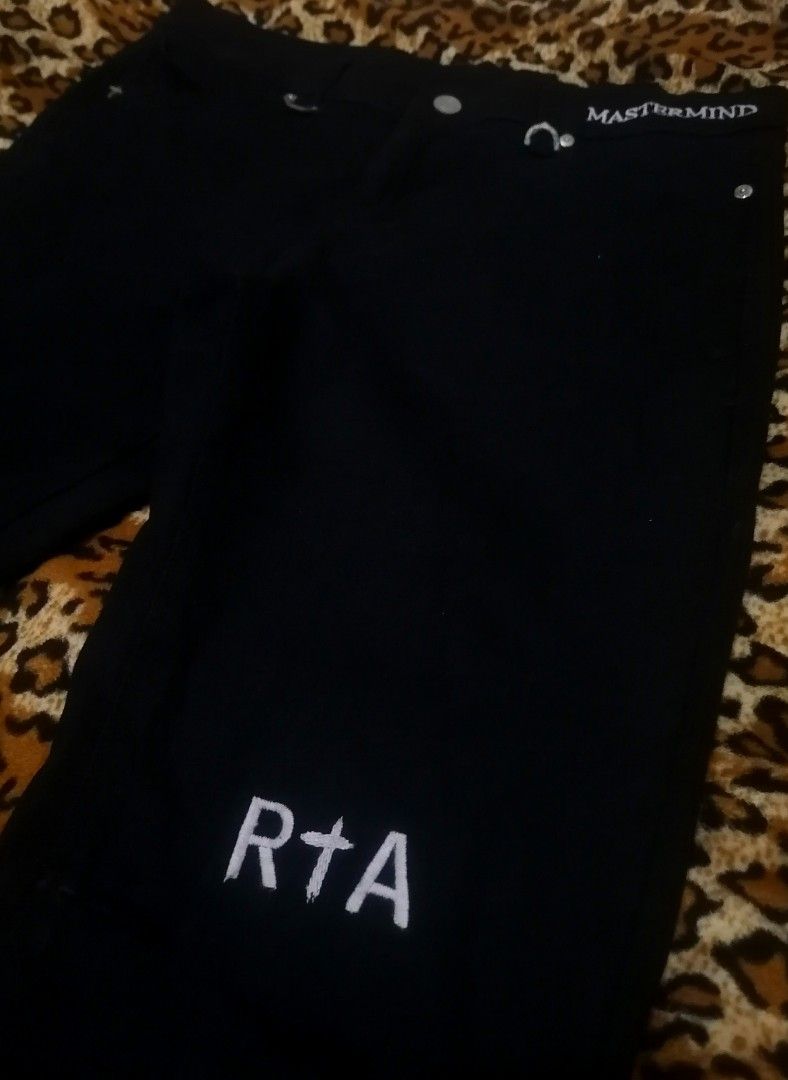 Mastermind World RTA Black Jeans (Category: Jeans) located in Cebu City. Submitted by roadthrift (Listing ID 1406767618, Image 3). Description: - Black jeans with Mastermind World and RTA branding. - Features a skull and crossbones design on the front. - Includes white cross details and RTA branding on the back. - Made in Los Angeles. - Crafted from 100% cotton..