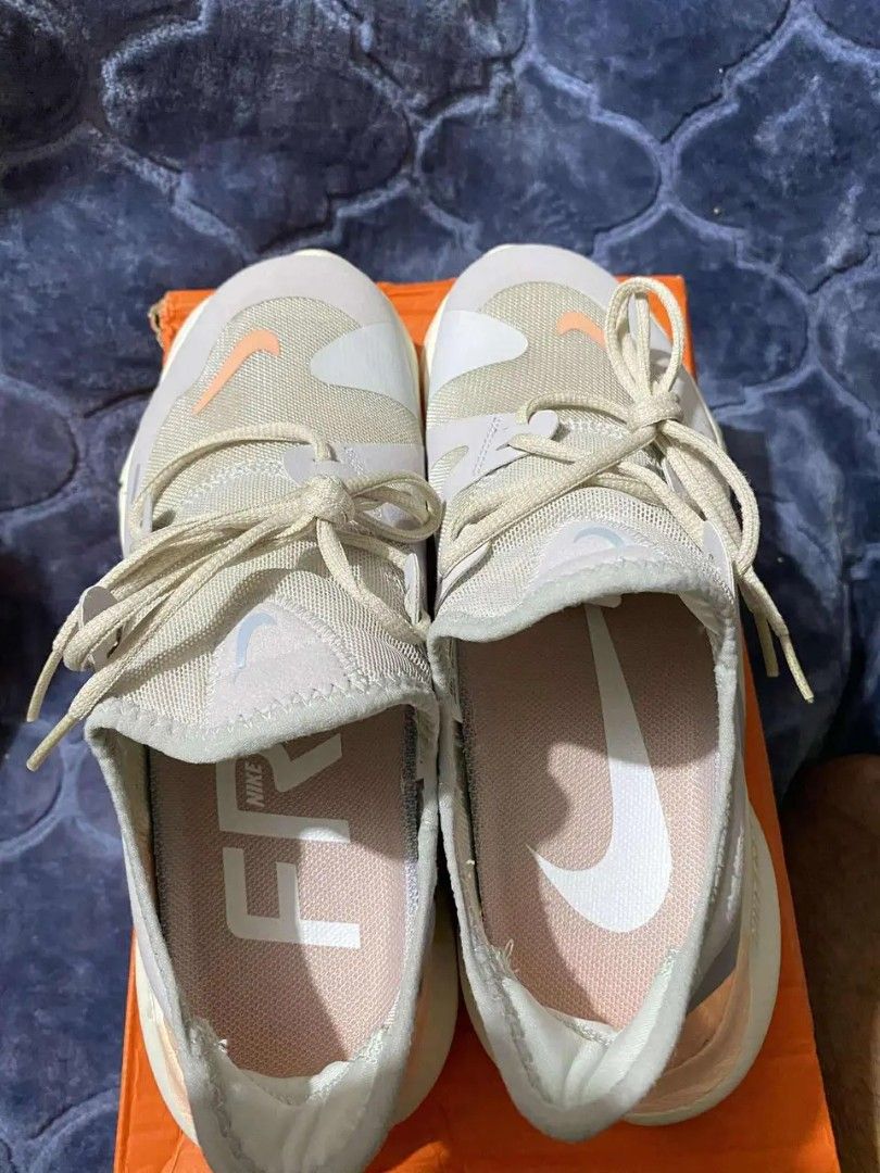 Nike Free RN 5.0 Running Shoes - Size 8 (Category: Sneakers) located in Taguig. Submitted by jerafelsan87737 (Listing ID 1406806929, Image 2). Description: - Nike Free RN 5.0 running shoes - Color: Light Grey/Orange - Size: US 8, UK 5.5, EUR 39, 25 CM - Features: Breathable mesh upper, flexible sole - Includes original box - Made in Vietnam.