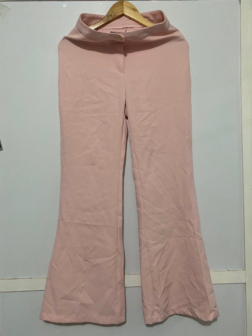 SHEIN Pink Flare Pants (Category: Other Bottoms) located in San Pedro. Submitted by jen.declutter (Listing ID 1406657387, Image 1). Description: - High-waisted pink flare pants - Features a button closure - Wide leg opening for a flattering fit - Made of smooth fabric - Solid light pink color Size 27-28 waist 41 inches length.