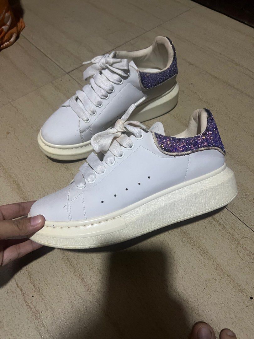 Alexander McQueen White Sneakers with Glitter Heel (Category: Sneakers) located in San Pedro. Submitted by zllerrzz (Listing ID 1406954631, Image 2). Description: - Alexander McQueen sneakers - White color - Chunky sole - Purple glitter heel counter - White laces - Brand name visible on sole Issue - Minor sole wear .
