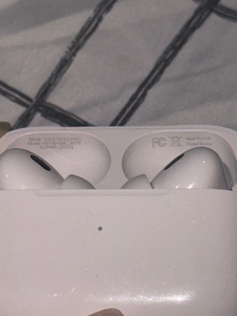 Apple AirPods Pro 2 (Category: Earphones) located in Angono. Submitted by xxxallaboutbagsxxx (Listing ID 1406938470, Image 2). Description: - Apple AirPods Pro with charging case - White color - Charging case with silver hinge and charging indicator light - Model number visible on the case - negotible!!.